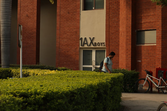 a man walking past a tall brick building