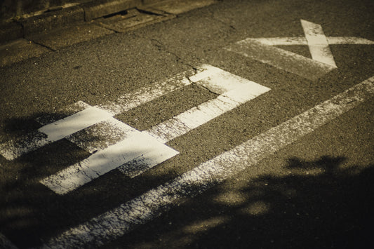 A street sign painted on the side of the road