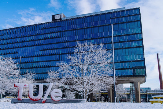 Modern building with tue sign in snow